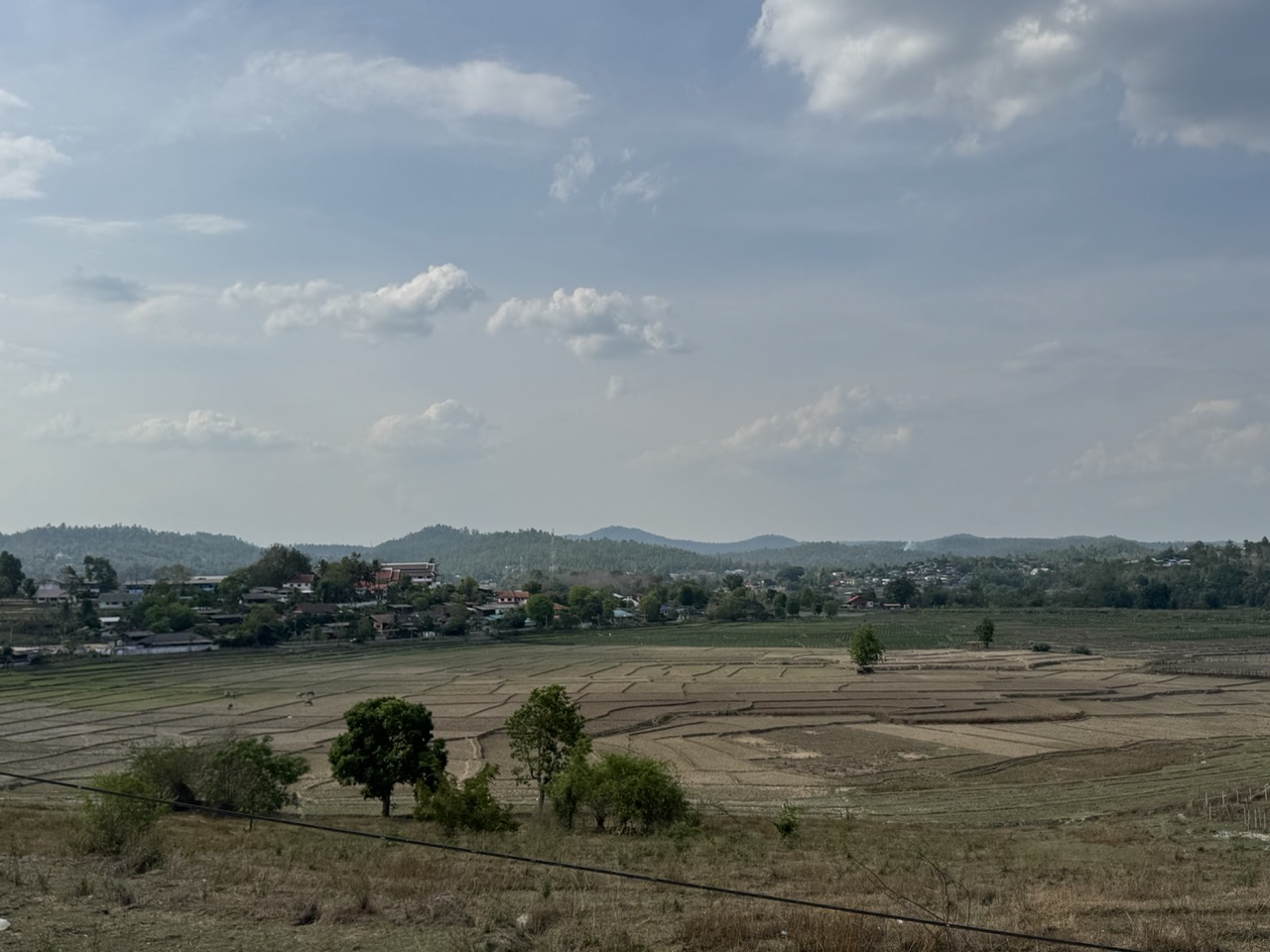 Dry rice paddies in late dry season — the valleys around Om Koi just before the rains arrive.