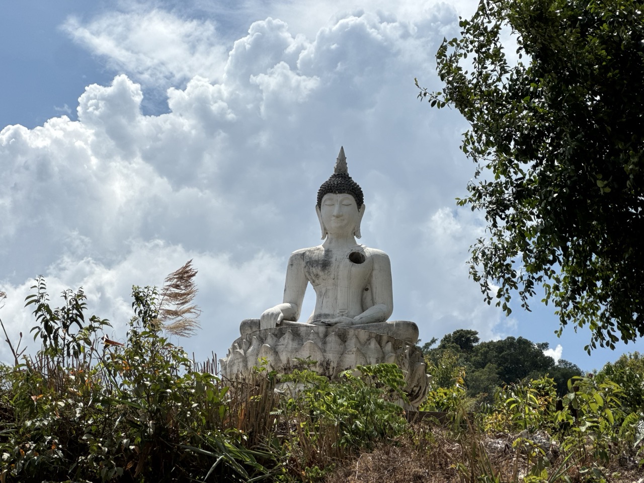 A white Buddha on the next hilltop over.