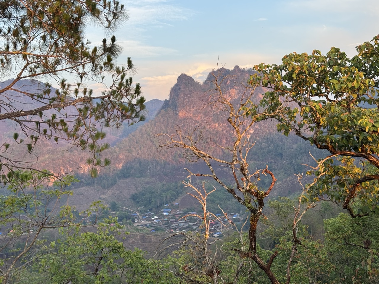 Pang Mapha at golden hour — pine-covered mountains and a village tucked into the valley.