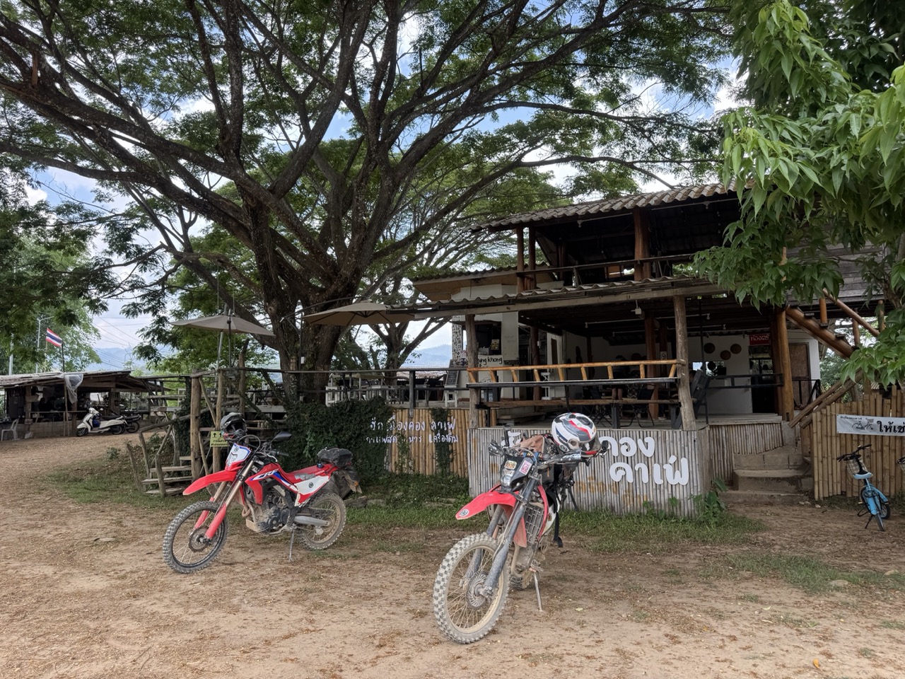 Two CRFs at a Chiang Dao roadside cafe — last stop before Chiang Mai.