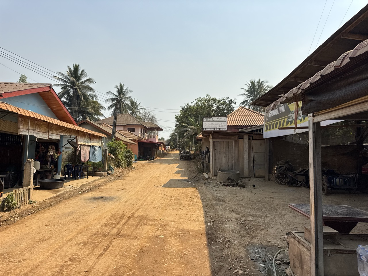 The 'main' road through a typical Lao village. Slow down, wave, keep going.