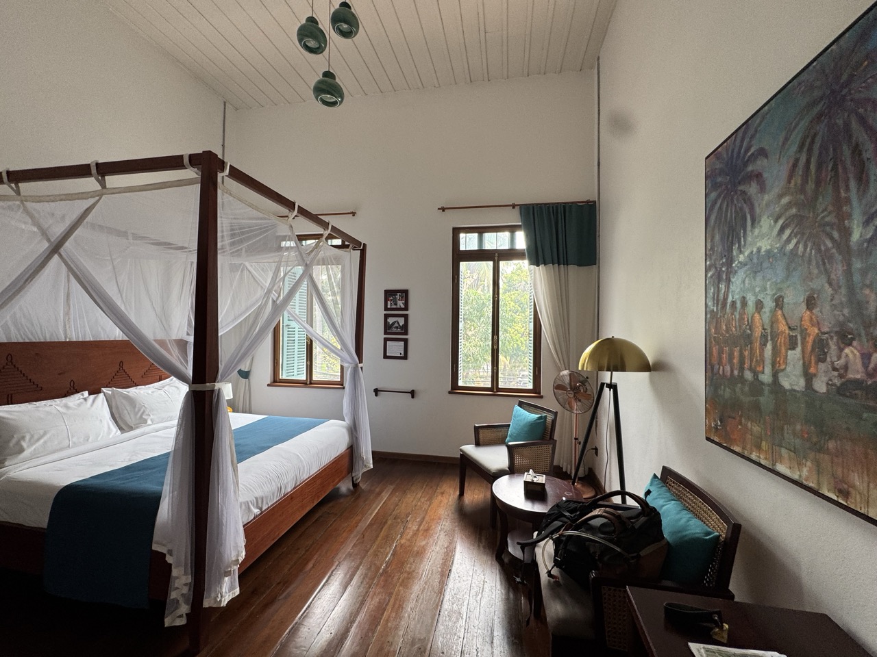 Four-poster room at Pha Nya Residence. Old colonial bones, fresh sheets.