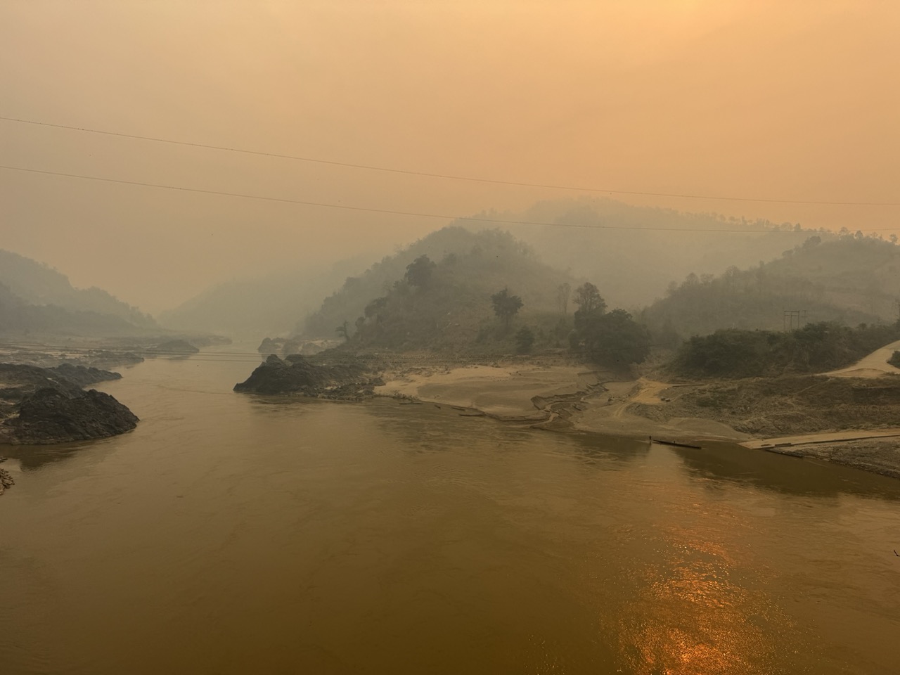 Hazy dawn river bend, viewed from a cliff pull-out climbing east out of Pak Beng.