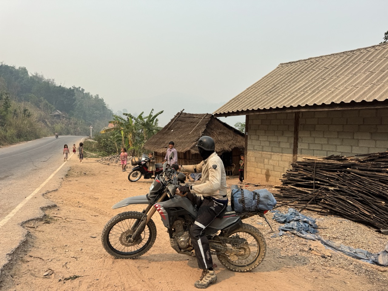 A village stop in Oudomxay. Kids appeared out of nowhere the moment the engines went quiet.