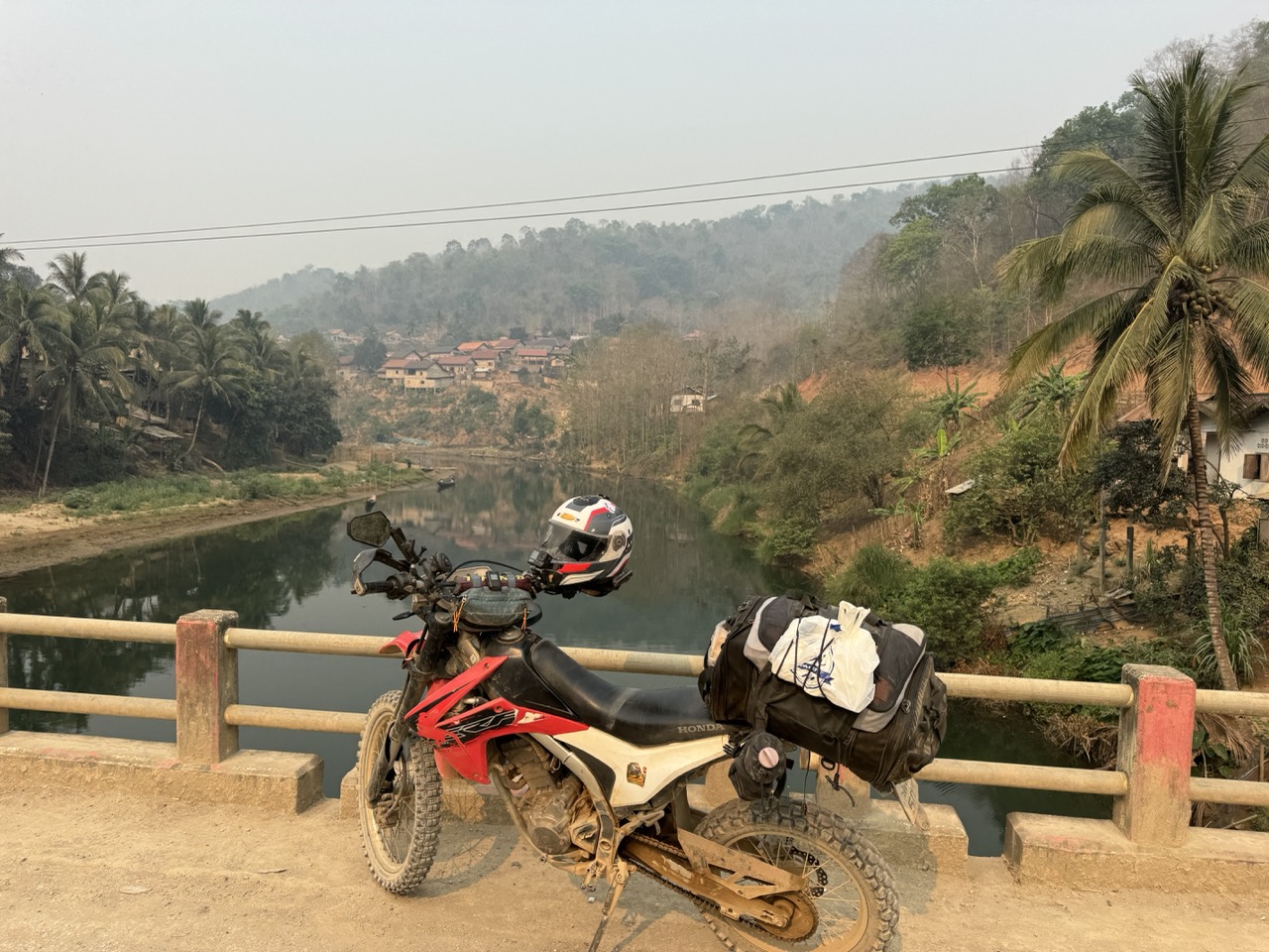 CRF stopped on a bridge over a still-green river. Clear water this far from the slash-and-burn slopes.