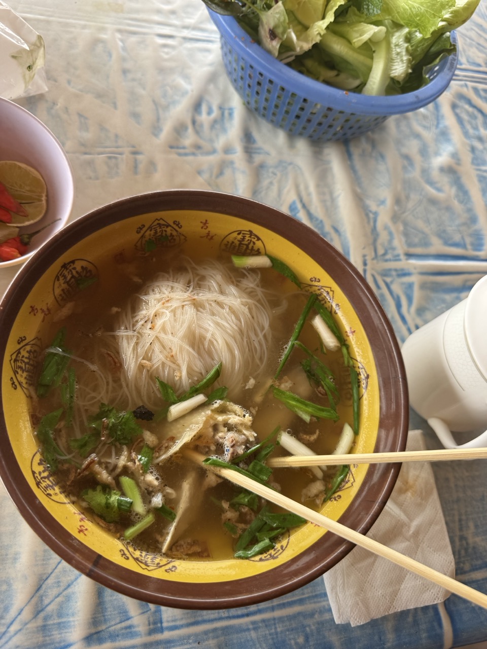 Lao noodle soup in a yellow ceramic bowl. ~25,000 kip and you keep going.