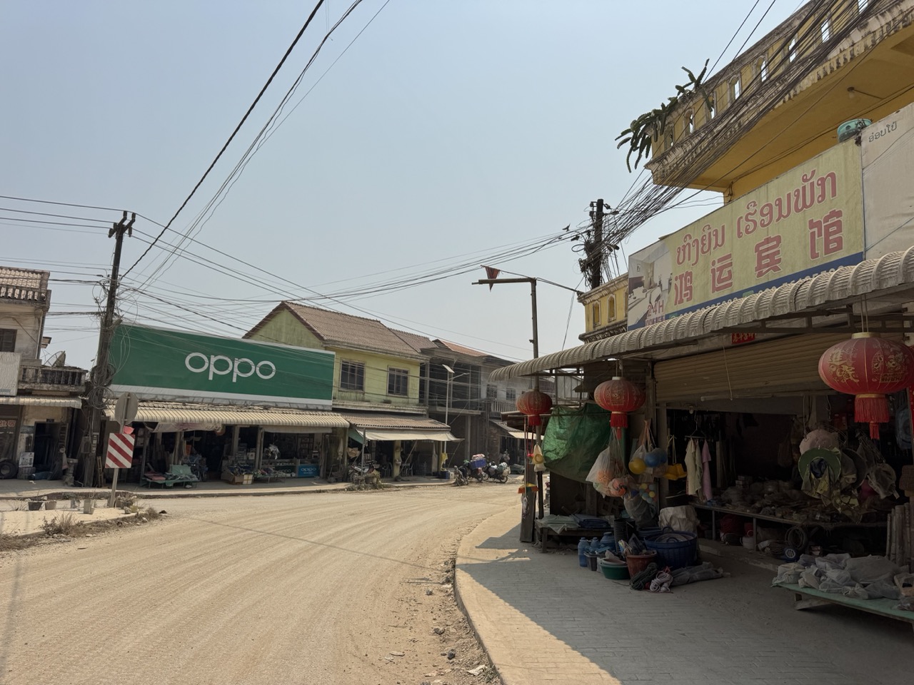Oppo storefront on a dirt main street in a small Xieng Khouang town. The 21st century delivers itself to rural Laos one phone shop at a time.