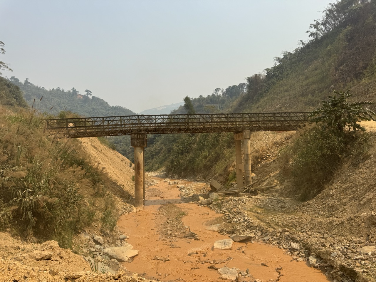 Rusty Bailey bridge over a dry gulch.