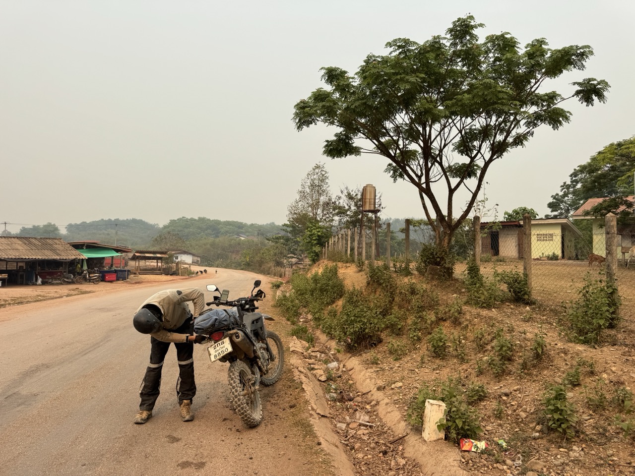 Securing luggage at a village stop. The straps loosen up when the road gets bumpy.