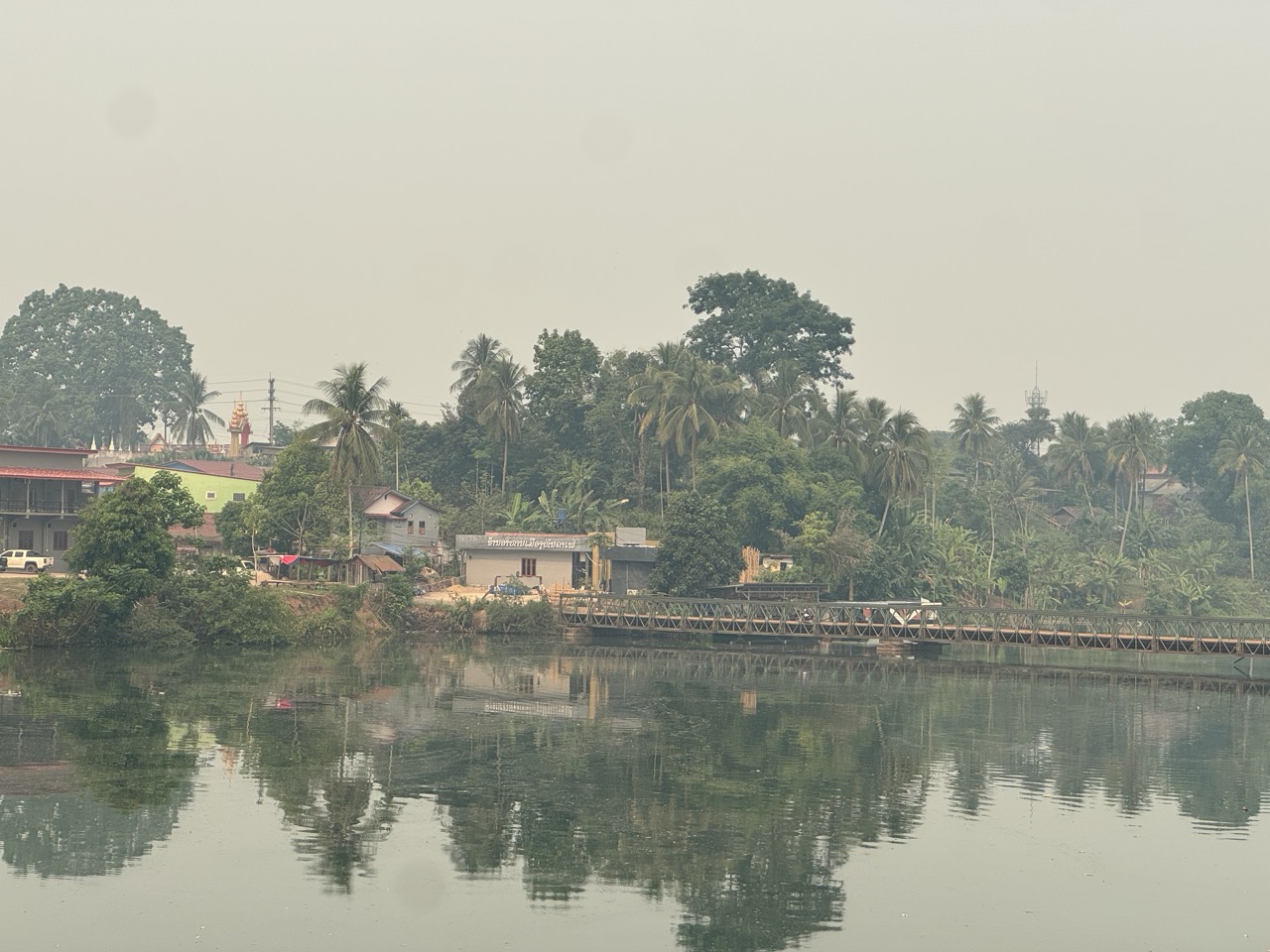 River view from another bridge, stupa on the far bank.