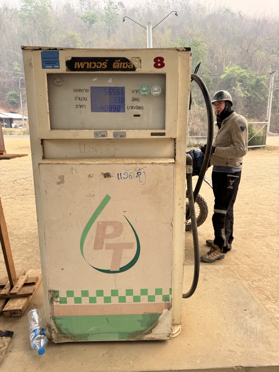 First petrol stop back in Thailand — Thai script on the pump, 91 octane, the small relief of being on familiar ground again. About six hours of riding from here to Chiang Mai.