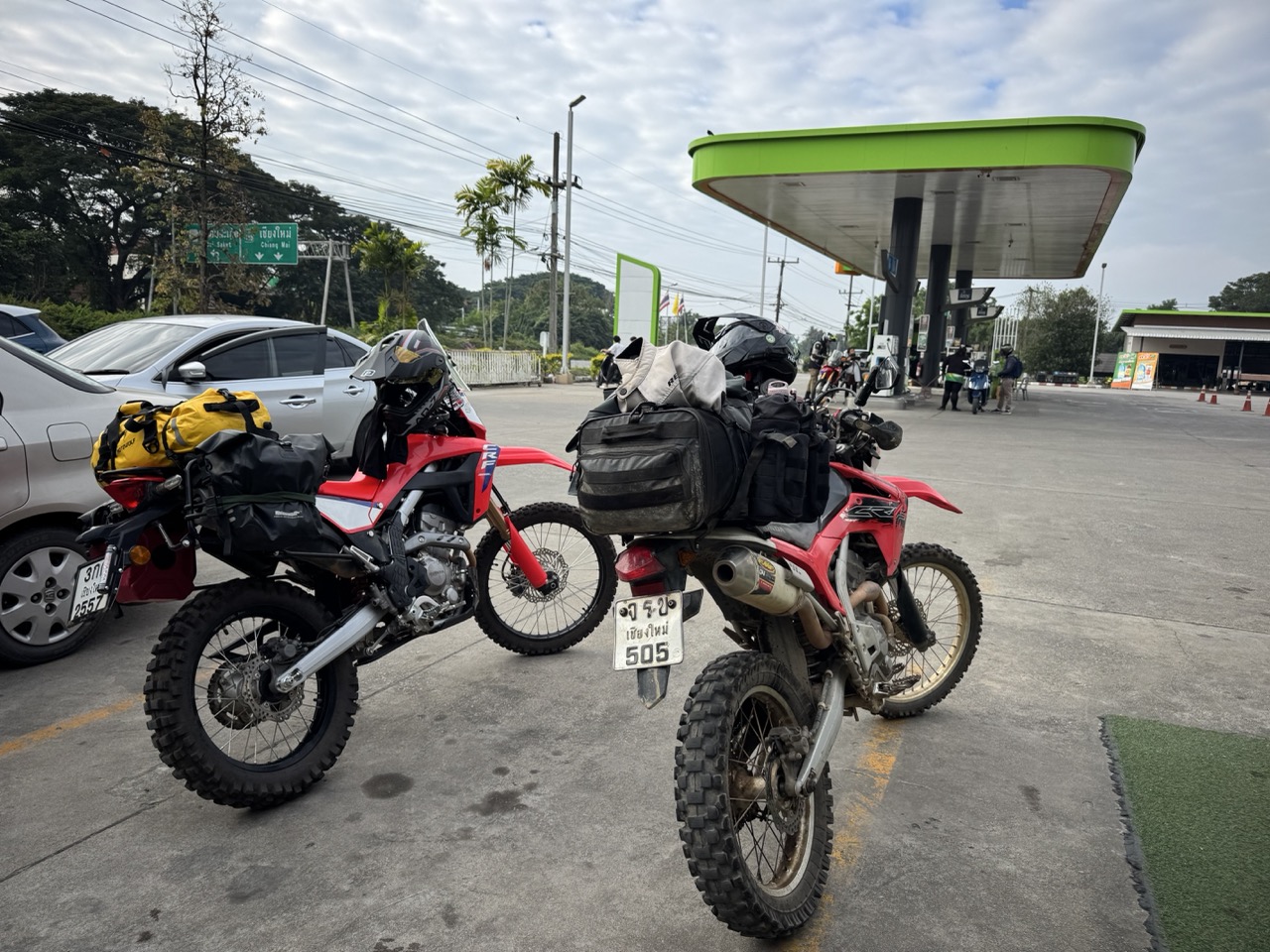 Loaded up at a Caltex on the north side of Chiang Mai, dawn of Day 1 — two CRFs and a long way north.