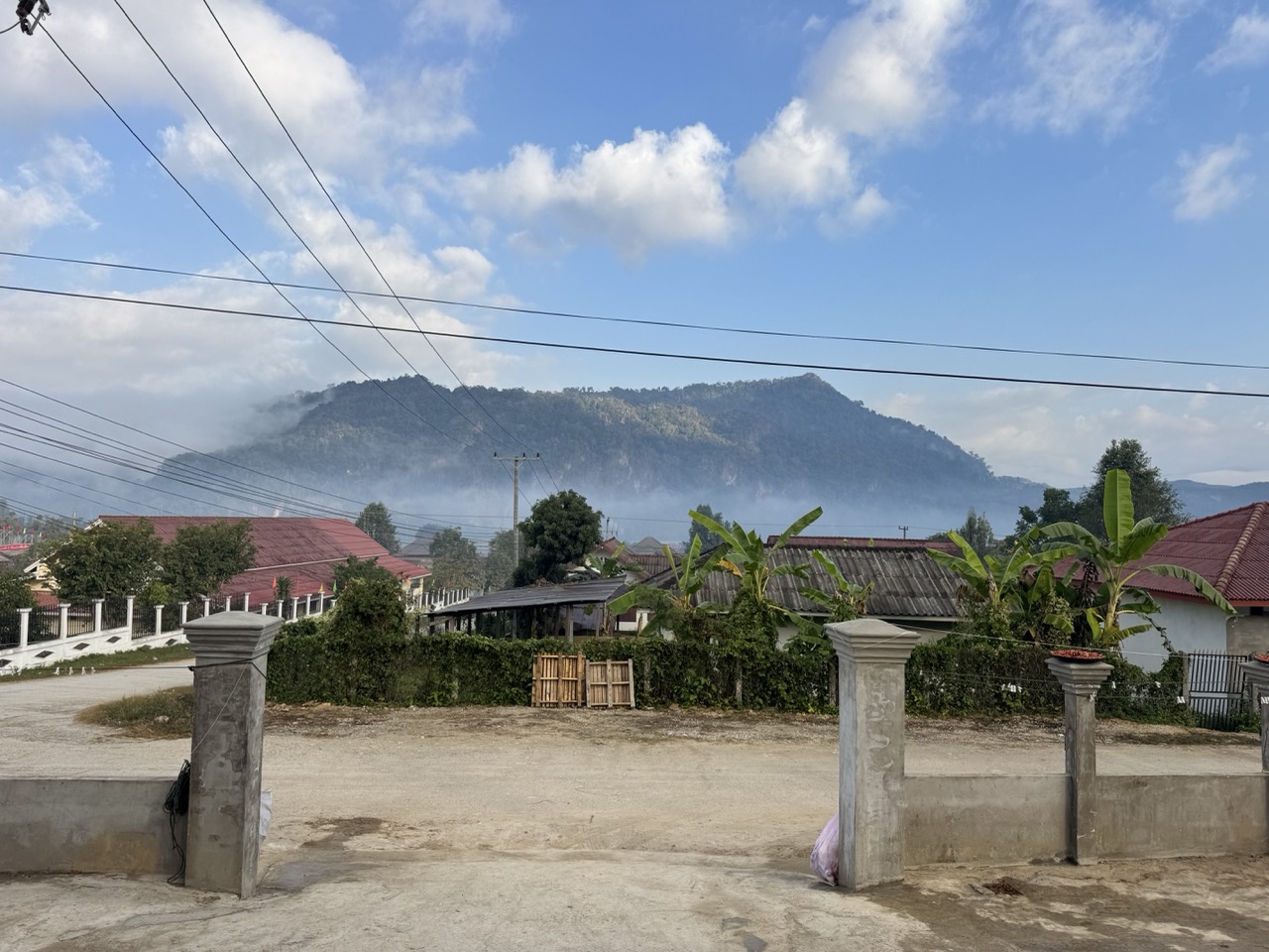 Morning haze burning off over a valley village leaving Muang Long.