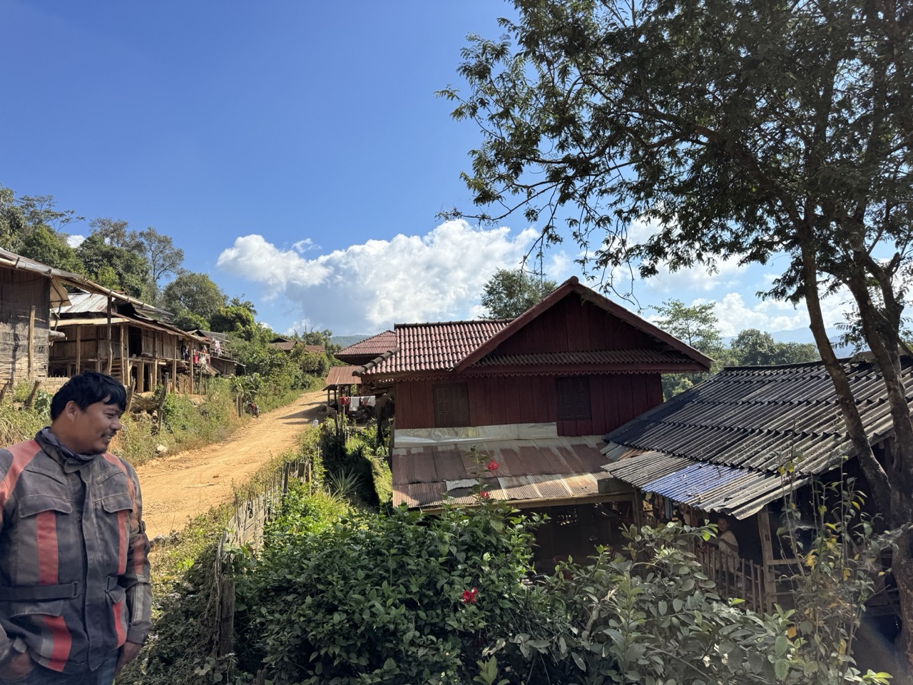 Hill-tribe village along the road — one of dozens we rode through on Day 3.