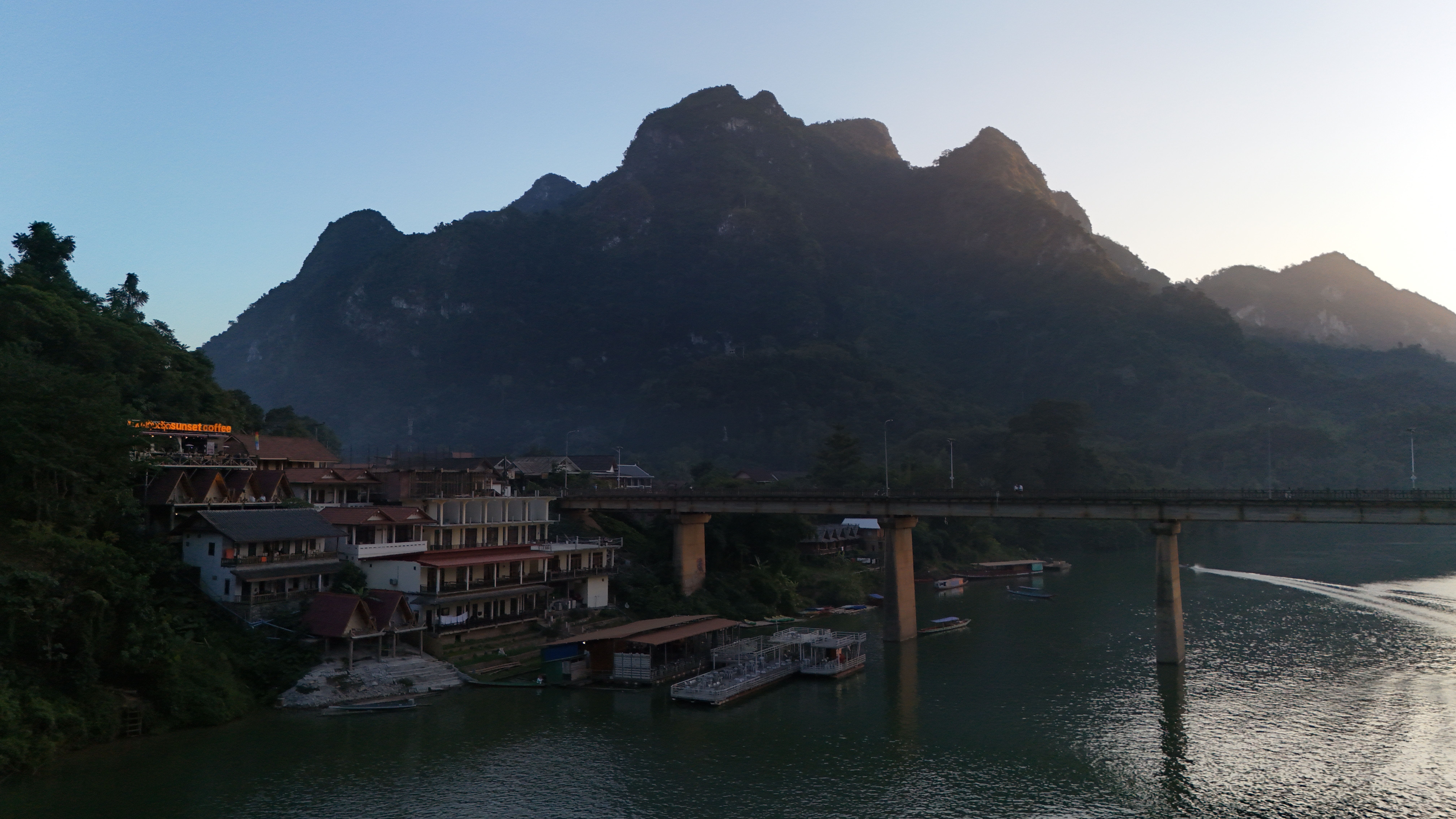 The signature shot of Nong Khiaw — limestone karst peak above the Nam Ou bridge in late-afternoon light.